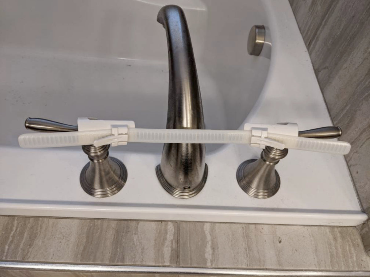 EXT.- Tub:  Faucet Handle Restraint