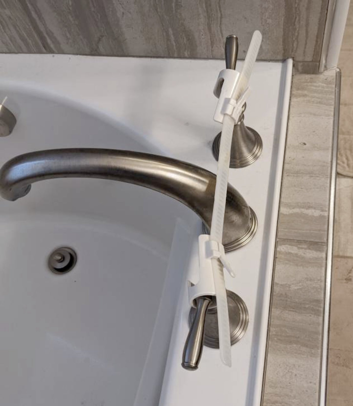 EXT.- Tub:  Faucet Handle Restraint